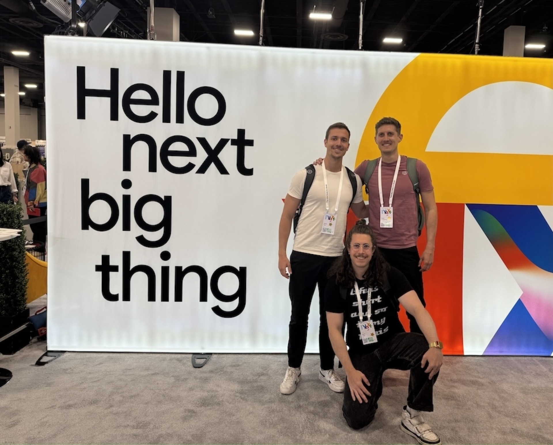 Kevin Duss, David Konatschnig und Gerrit Merz, IT-Experten von ipt, posieren vor einem Plakat an der Google Cloud Next 2024.