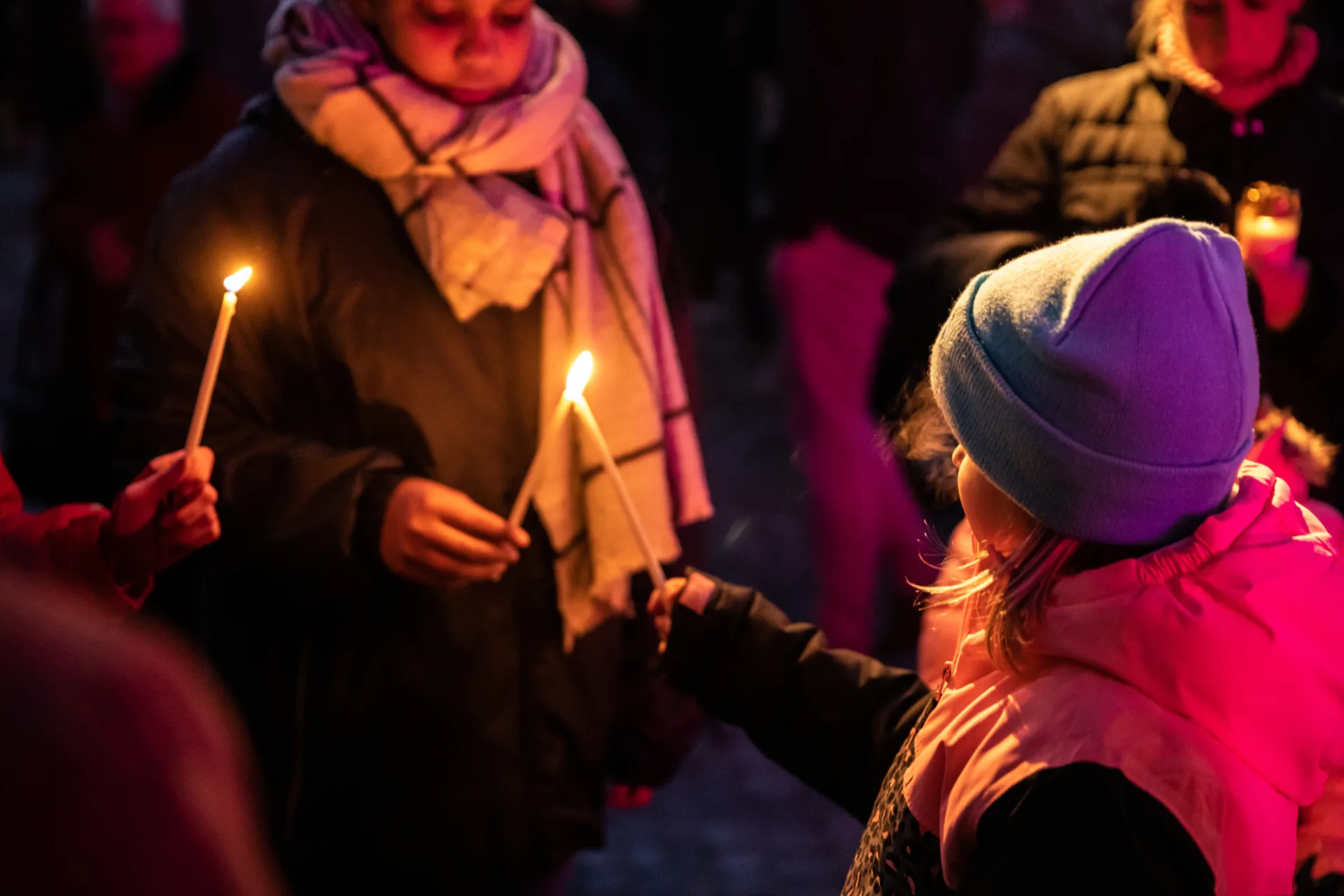 Kinder geben Kerzenlicht weiter. Kinder geben Kerzenlicht weiter.